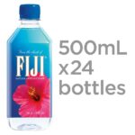 FIJI Water bottle with tropical background and palm leaves.